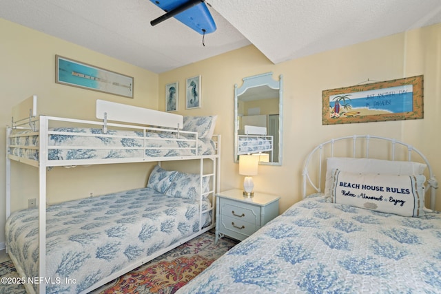 bedroom with ceiling fan and a textured ceiling