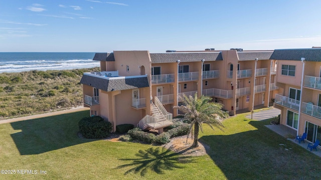 view of property featuring a water view and a beach view