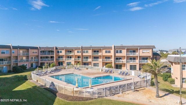 view of pool with a lawn