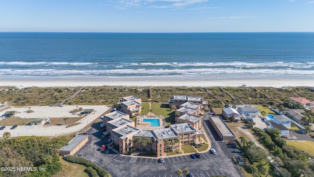 drone / aerial view with a beach view and a water view