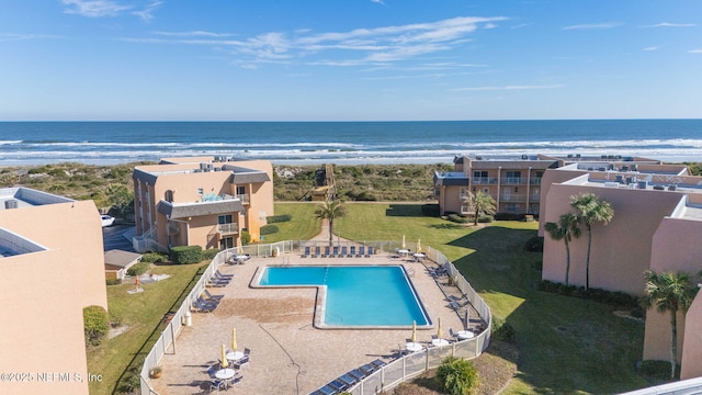 view of swimming pool featuring a water view and a view of the beach