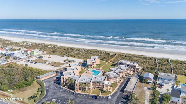 aerial view with a water view and a beach view