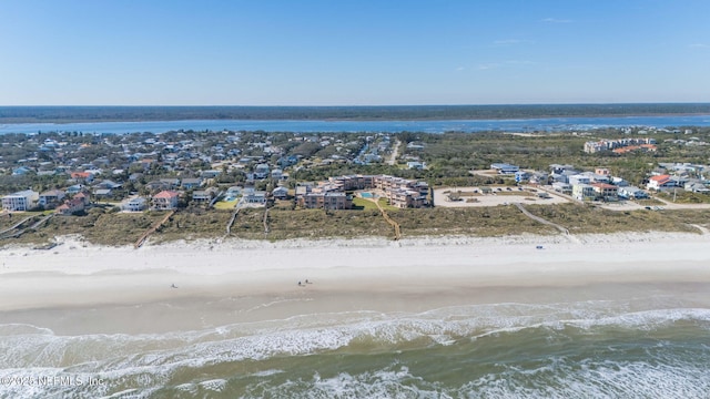 drone / aerial view with a water view and a beach view