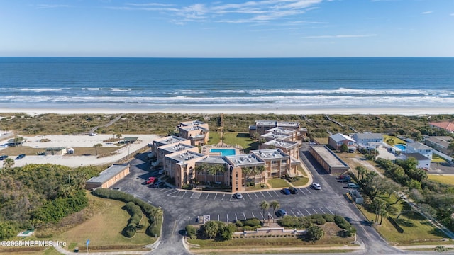 bird's eye view featuring a water view and a beach view