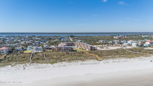 drone / aerial view featuring a water view and a beach view