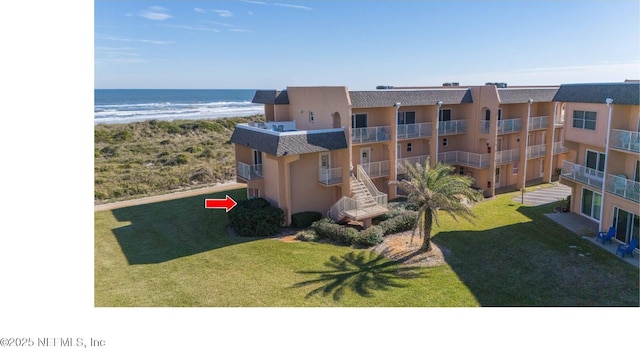 exterior space featuring a view of the beach and a water view