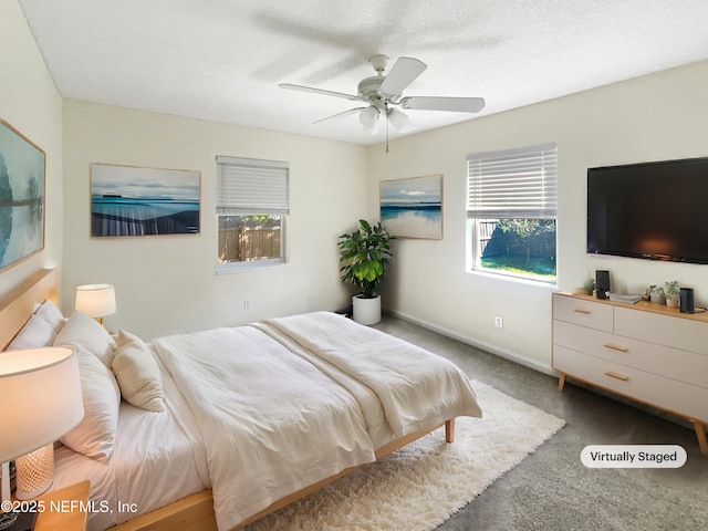 bedroom with ceiling fan, carpet, and baseboards