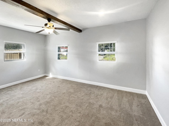 carpeted empty room with beam ceiling, ceiling fan, and baseboards