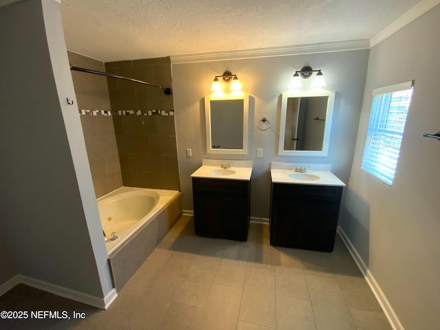 bathroom with a textured ceiling, two vanities, a sink, and shower / tub combination