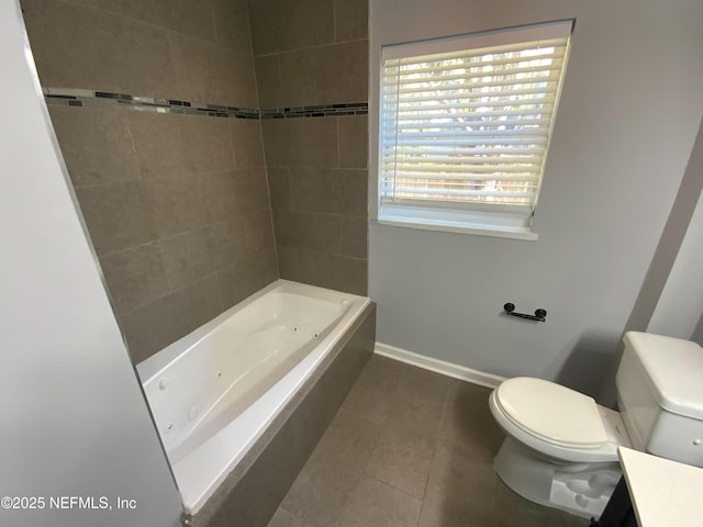 bathroom with toilet, vanity, baseboards, a combined bath / shower with jetted tub, and tile patterned floors