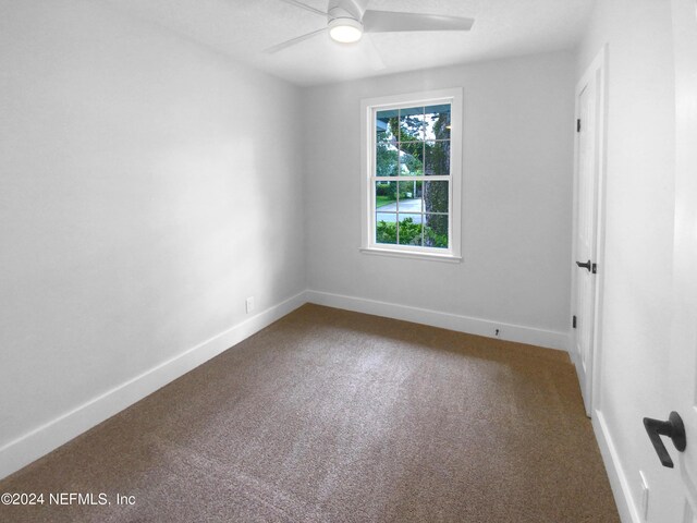 carpeted empty room with ceiling fan