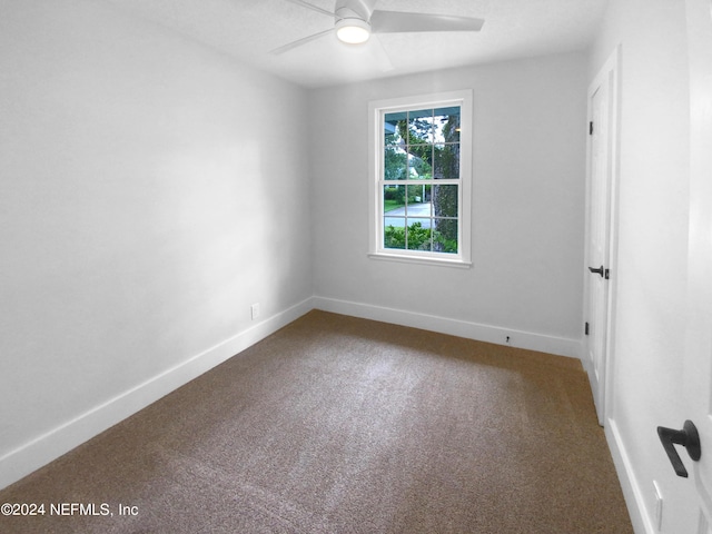 spare room with baseboards, carpet floors, and ceiling fan