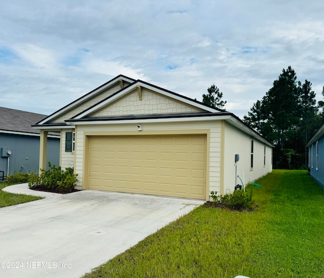 exterior space featuring a front lawn and a garage