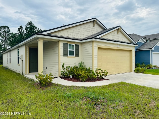 view of front facade with a garage and a front lawn