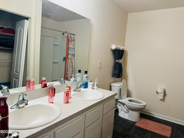 bathroom featuring walk in shower, toilet, a textured ceiling, and vanity