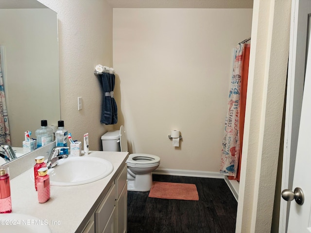 bathroom with vanity, toilet, a shower with curtain, and hardwood / wood-style flooring