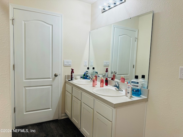 bathroom with hardwood / wood-style flooring and vanity