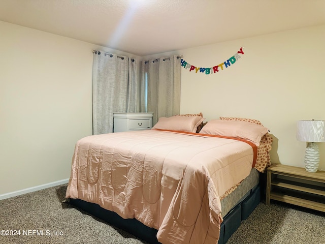 bedroom featuring dark colored carpet