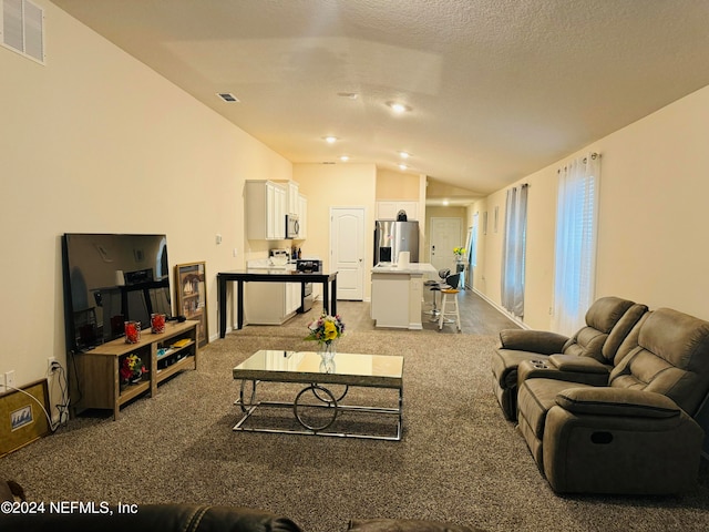 living room with a textured ceiling, carpet flooring, and lofted ceiling