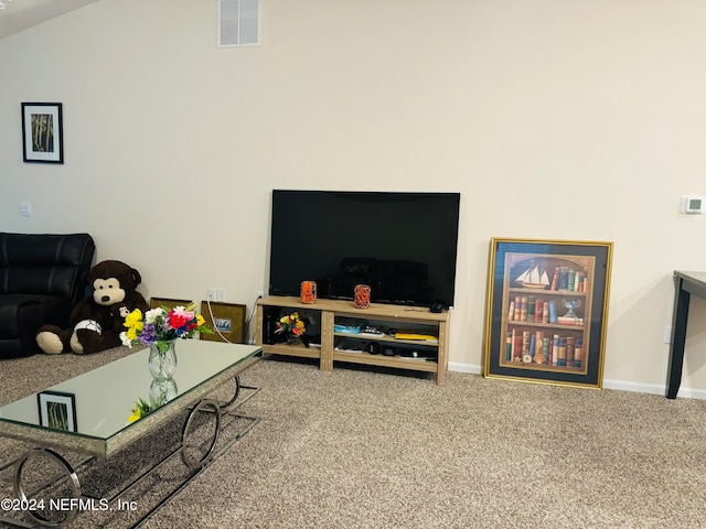 carpeted living room with lofted ceiling