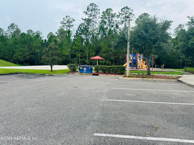 view of parking with a playground