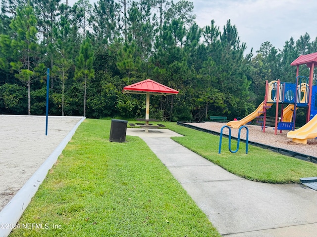 view of home's community with a playground and a yard