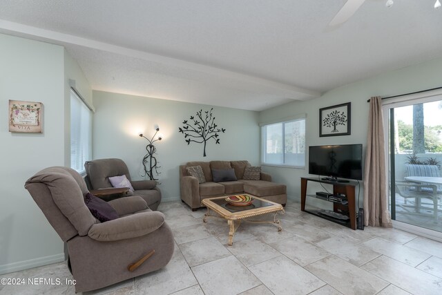 living room with ceiling fan and light tile patterned floors