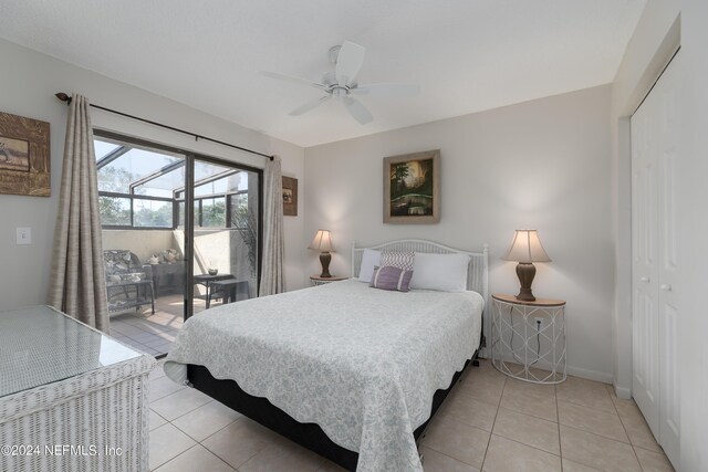 bedroom featuring light tile patterned flooring, ceiling fan, and a closet