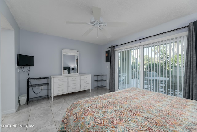 bedroom featuring a textured ceiling, ceiling fan, light tile patterned floors, and access to outside