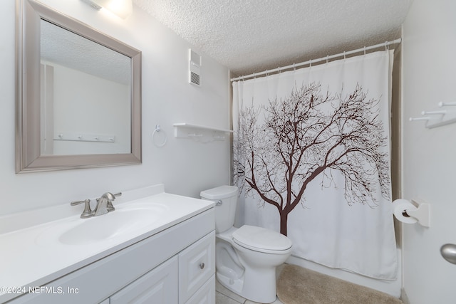 bathroom with vanity, toilet, walk in shower, and a textured ceiling