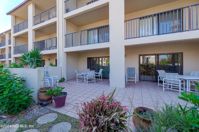 view of patio featuring a balcony