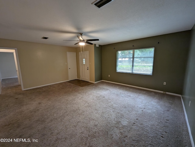 unfurnished room featuring carpet floors, a textured ceiling, and ceiling fan