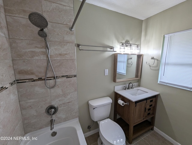 full bathroom with tiled shower / bath combo, vanity, toilet, and tile patterned floors