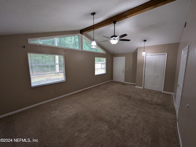 interior space featuring ceiling fan, vaulted ceiling with beams, and carpet flooring