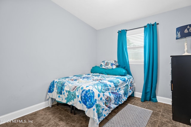 bedroom featuring vaulted ceiling