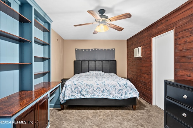 bedroom with ceiling fan and wooden walls