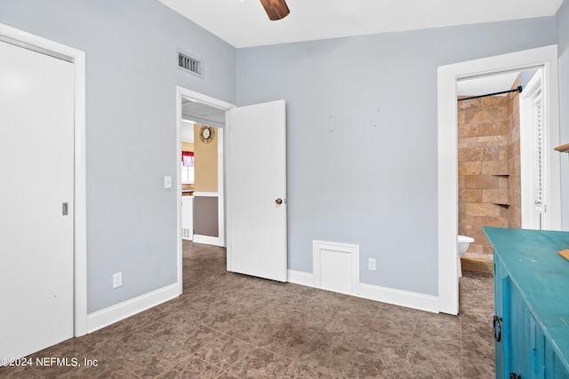 unfurnished bedroom with ensuite bath and ceiling fan