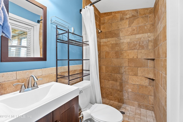 bathroom featuring a shower with curtain, toilet, and vanity