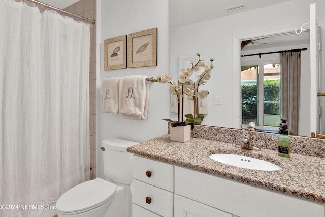 bathroom with vanity, toilet, and ceiling fan