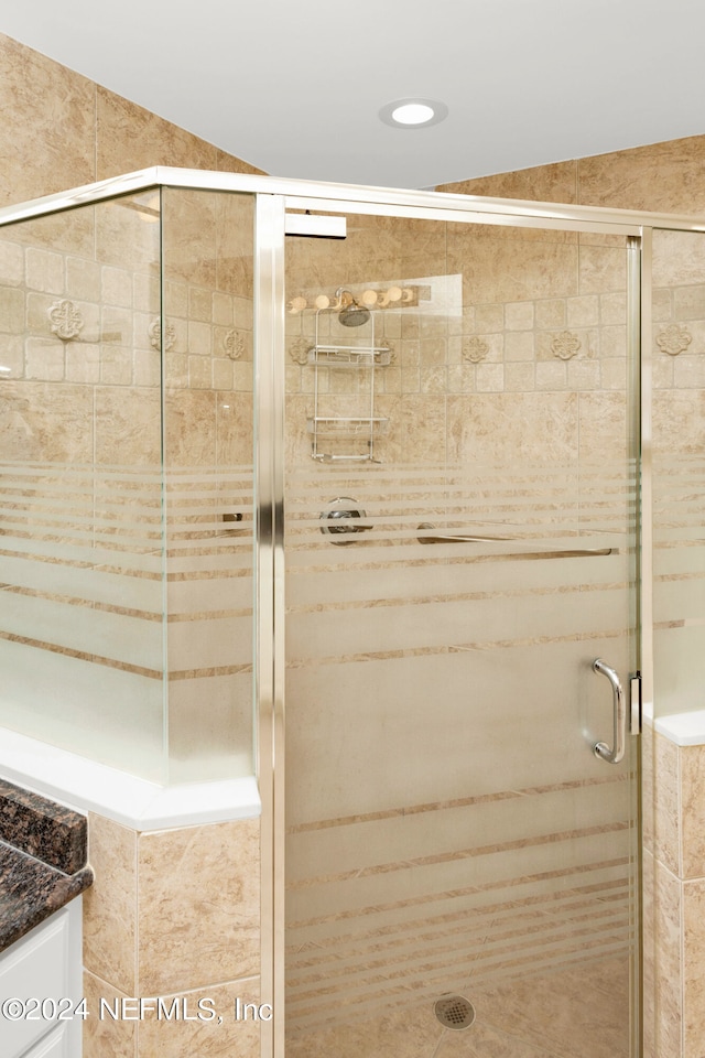 bathroom with vanity and an enclosed shower