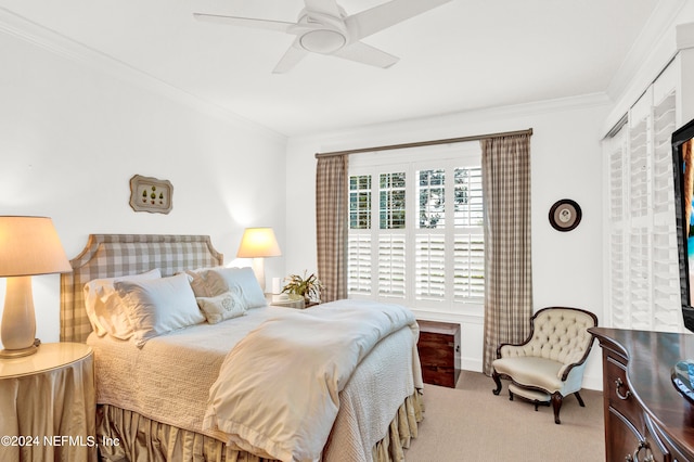 carpeted bedroom with ceiling fan and crown molding