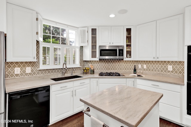 kitchen featuring appliances with stainless steel finishes, white cabinetry, sink, and dark hardwood / wood-style floors