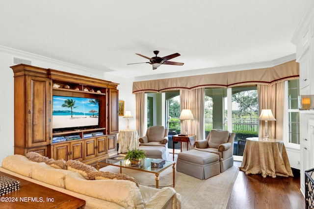 living room featuring a healthy amount of sunlight, crown molding, ceiling fan, and hardwood / wood-style flooring