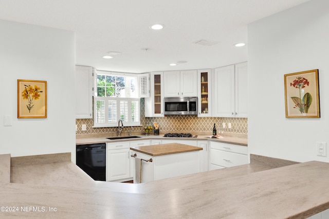 kitchen with white cabinetry, appliances with stainless steel finishes, tasteful backsplash, and sink