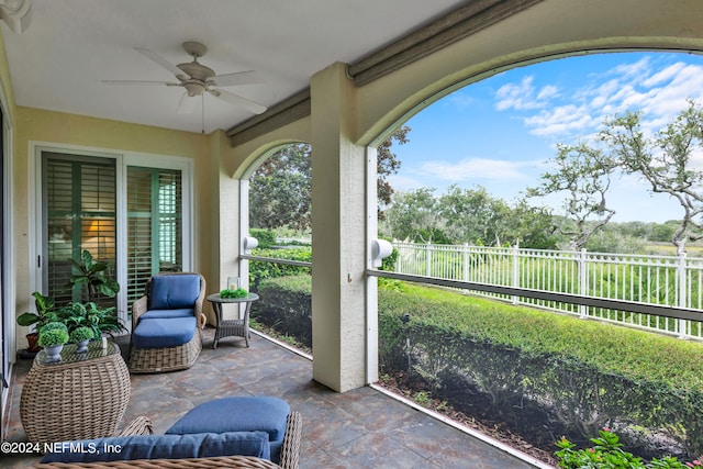 sunroom featuring ceiling fan