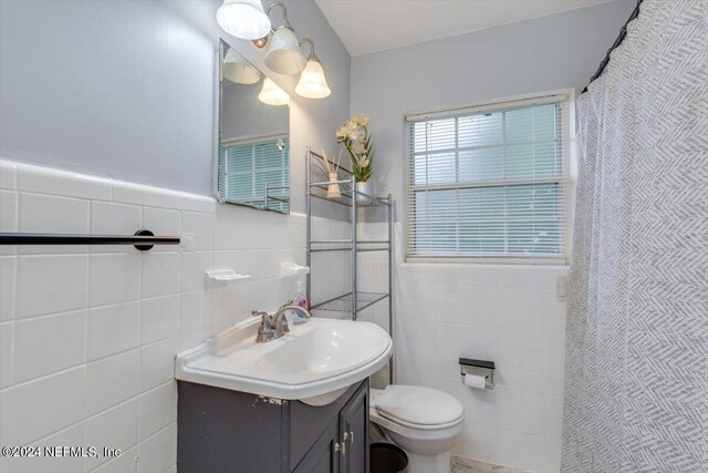 bathroom featuring tile walls, toilet, decorative backsplash, and vanity