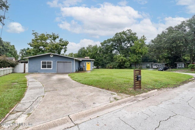 ranch-style house with a front lawn, fence, driveway, and a chimney