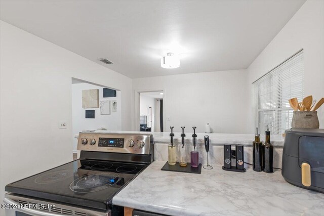 kitchen with stainless steel range with electric cooktop