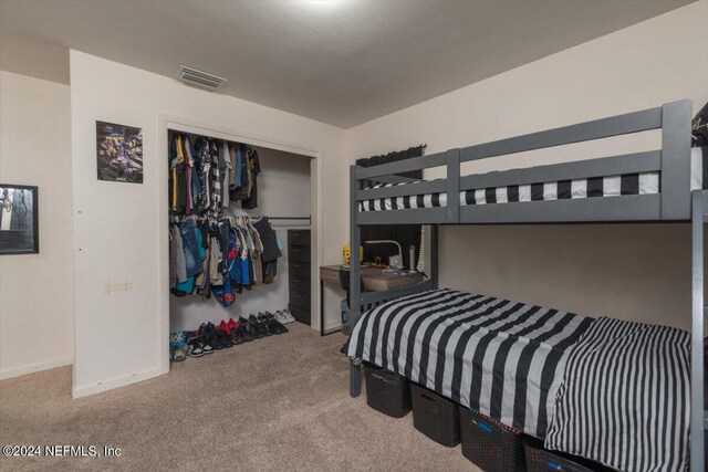 bedroom with a closet and carpet floors