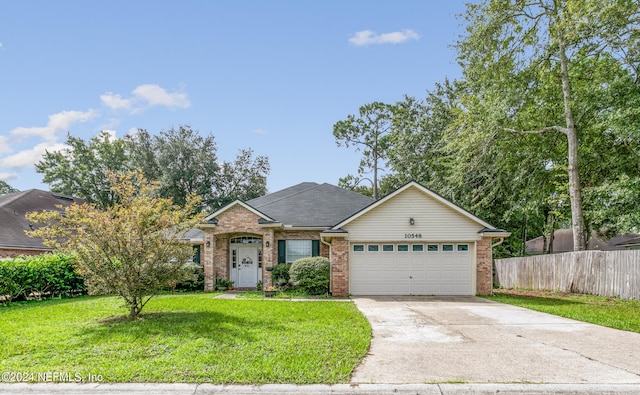 single story home with a garage and a front lawn